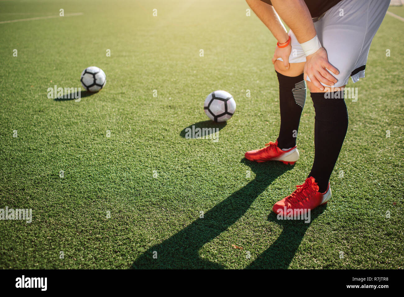 Football player on his two knees hires stock photography and images