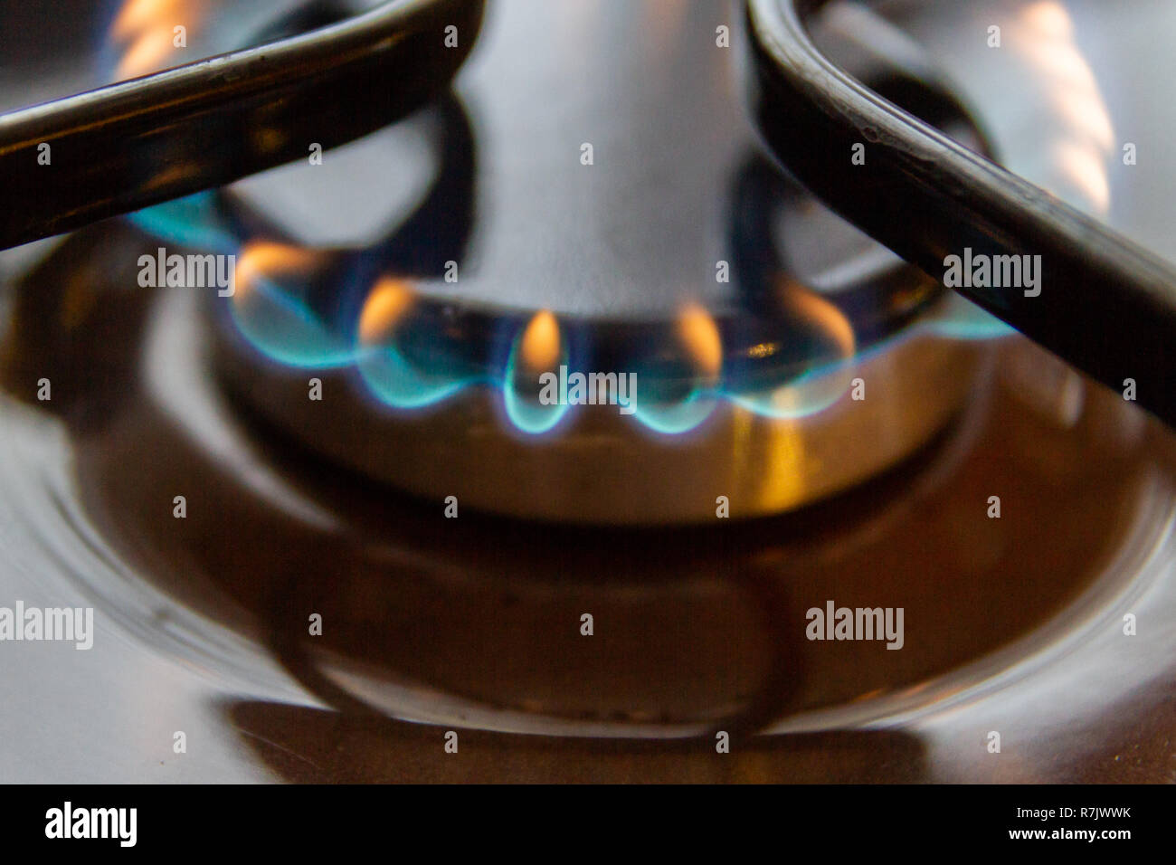 Gas stove with burning orange and blue fire on it Stock Photo Alamy