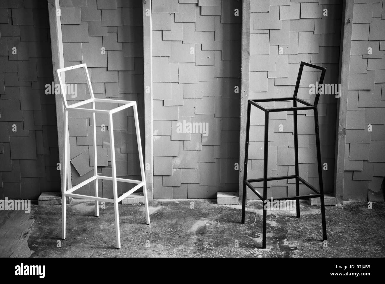 Black and white photo of two chairs facing each other in loft space