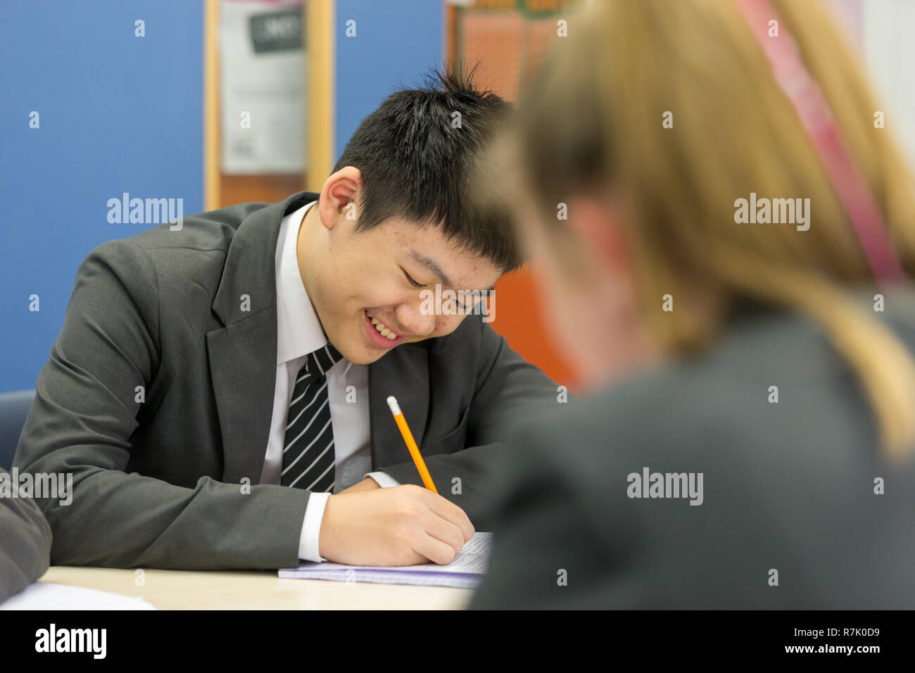 14 year old pupil in a classroom, eastern Asian ethnicity, UK Stock Photo