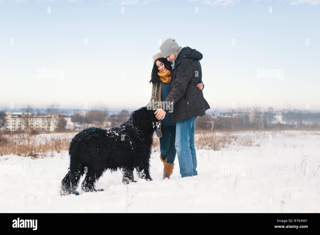 Pretty Man And Woman Enjoying The Snow While Walking With Their