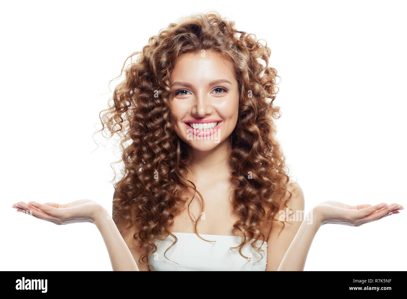Smiling woman showing open hand with empty copy space isolated on white ...