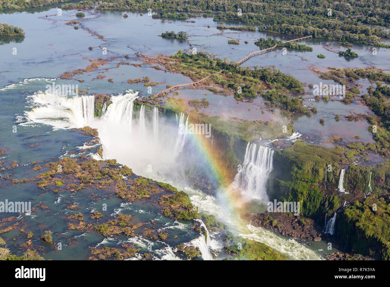 Aerial view of beautiful rainbow above Iguazu Falls Devil's Throat chasm from a helicopter flight. Brazil and Argentina. South America. Stock Photo