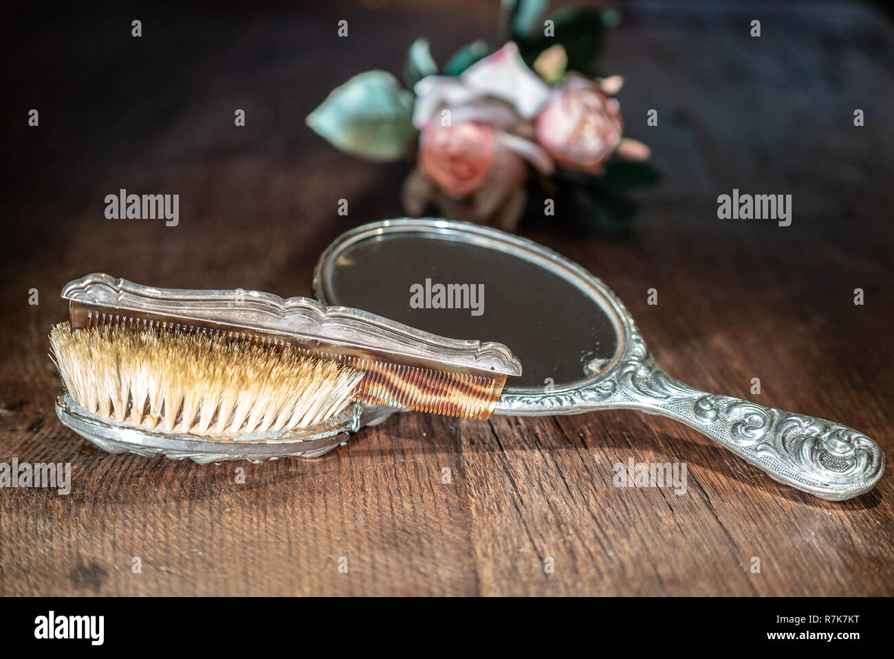 retro silver mirror and comb on old wooden table Stock Photo