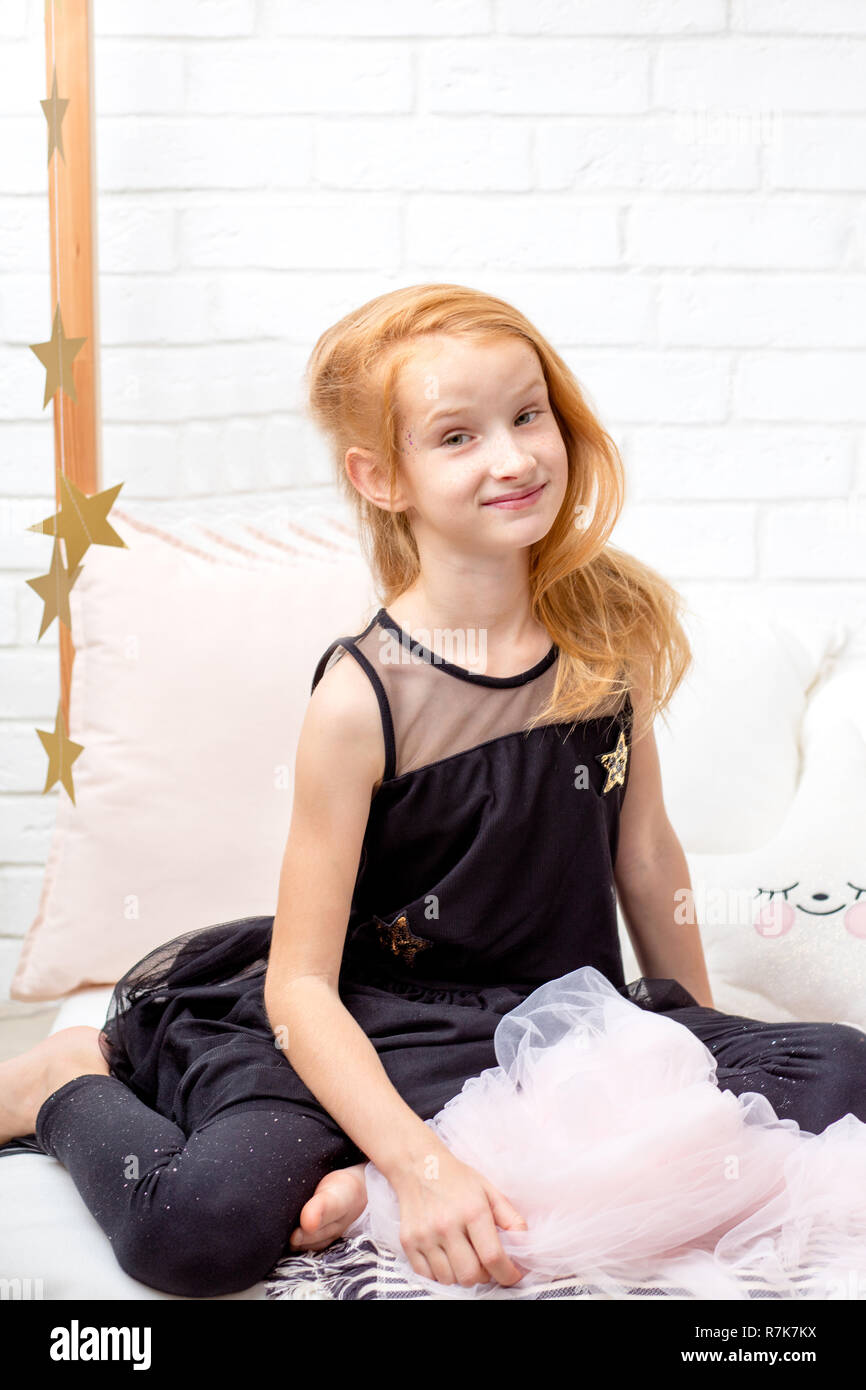 attractive nice ginger girl in beautiful clothes posing to the camera Stock Photo Alamy