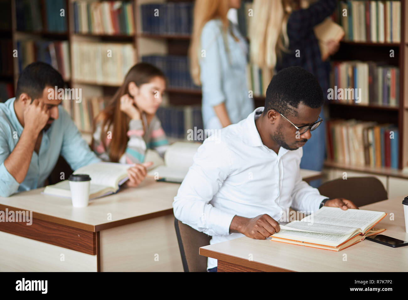 African american male college student preparing for exams in the library. Stock Photo