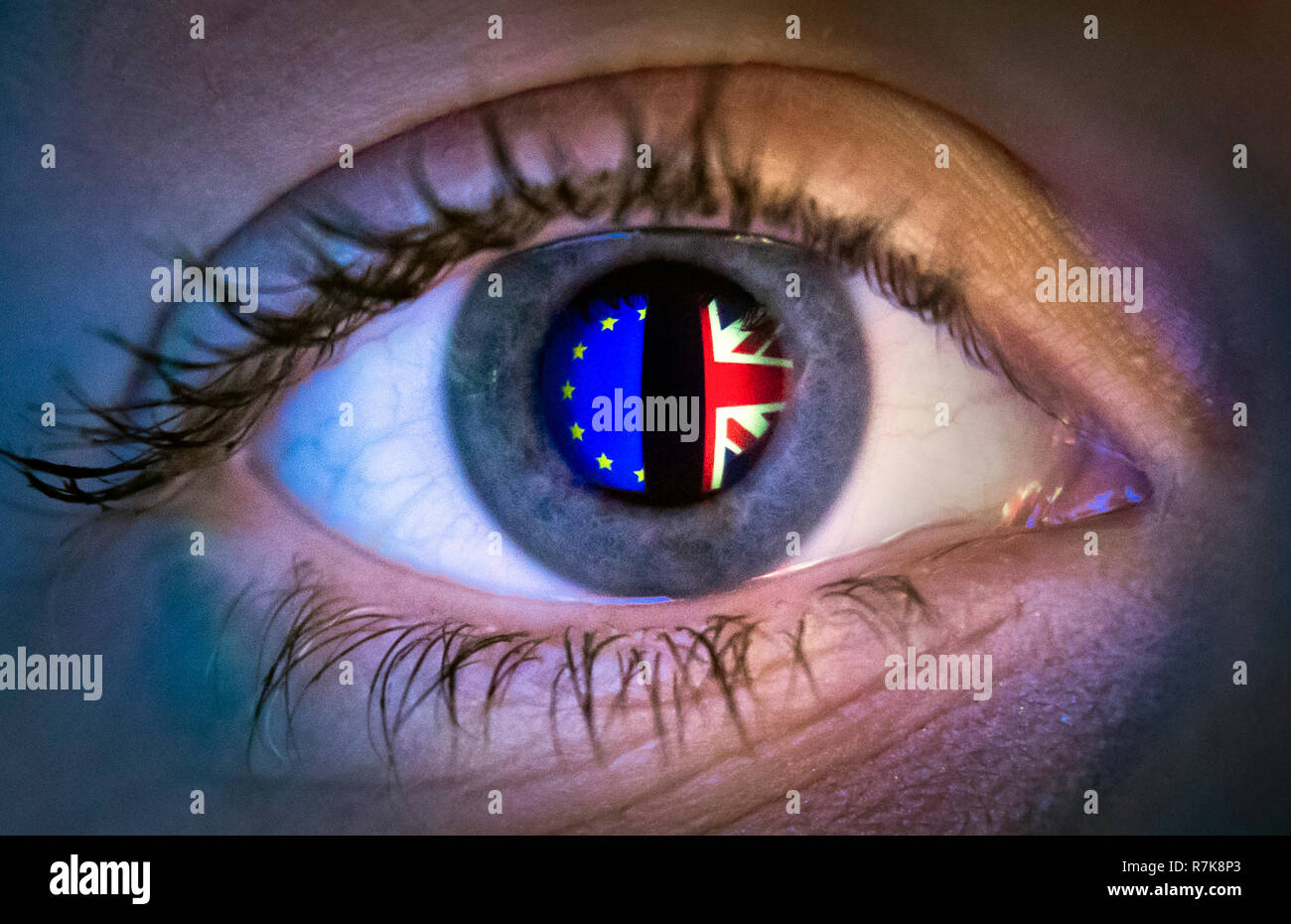 Reflections of a European flag (left) and Union flag, seen in a person's eye. Prime Minister Theresa May is calling off the vote on her Brexit deal in the face of what had been expected to be a significant defeat at the hands of rebel MPs. Stock Photo