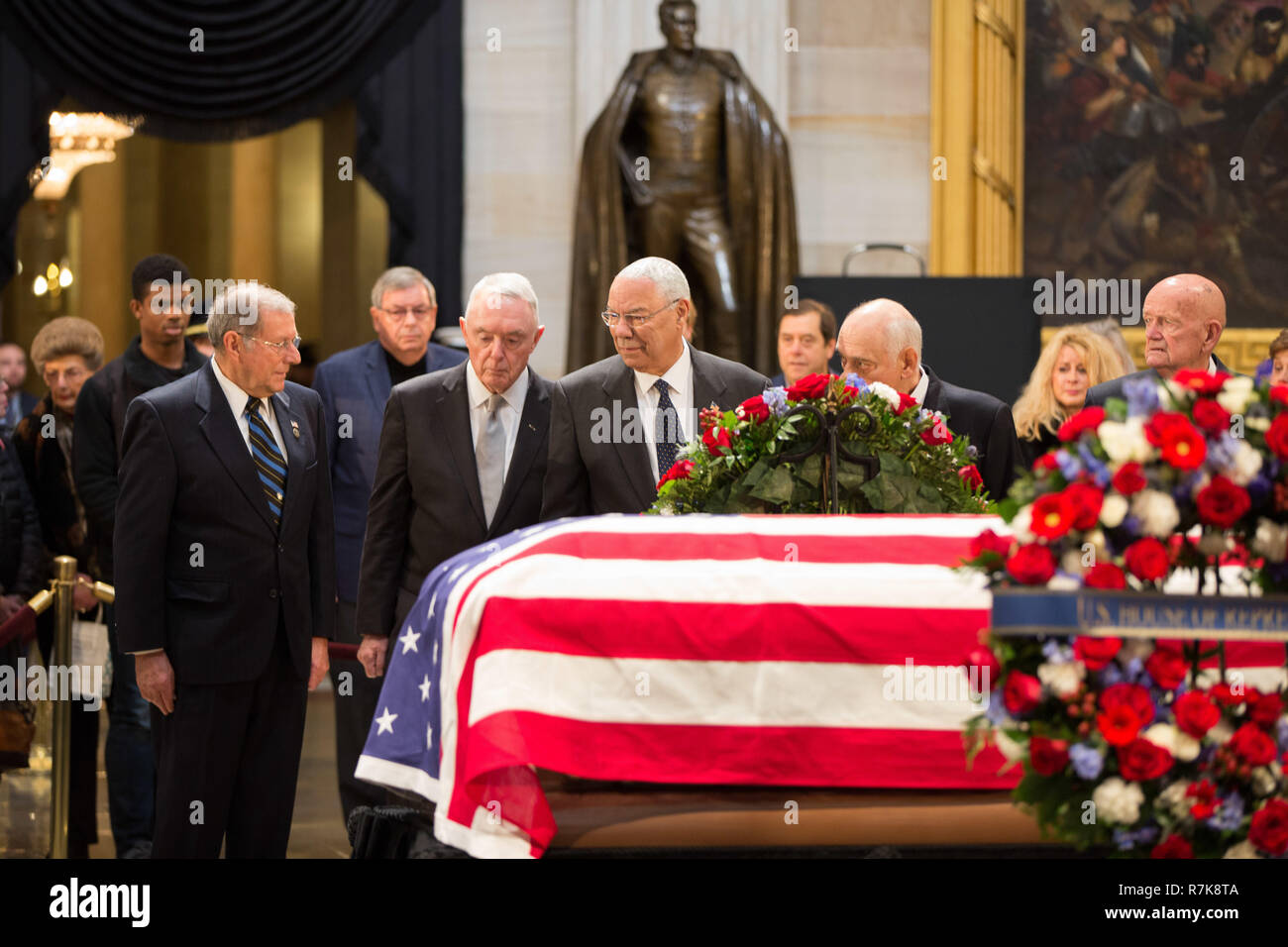 Former Secretary of State Colin Powell, center, Gen. Barry McCaffrey, left, and Gen. John Kelly pay their respects at the flag draped casket of former President George H. W. Bush as visitors file past as it lies in state at the Capitol Rotunda December 4, 2018 in Washington, DC. Bush, the 41st President, died in his Houston home at age 94. Stock Photo