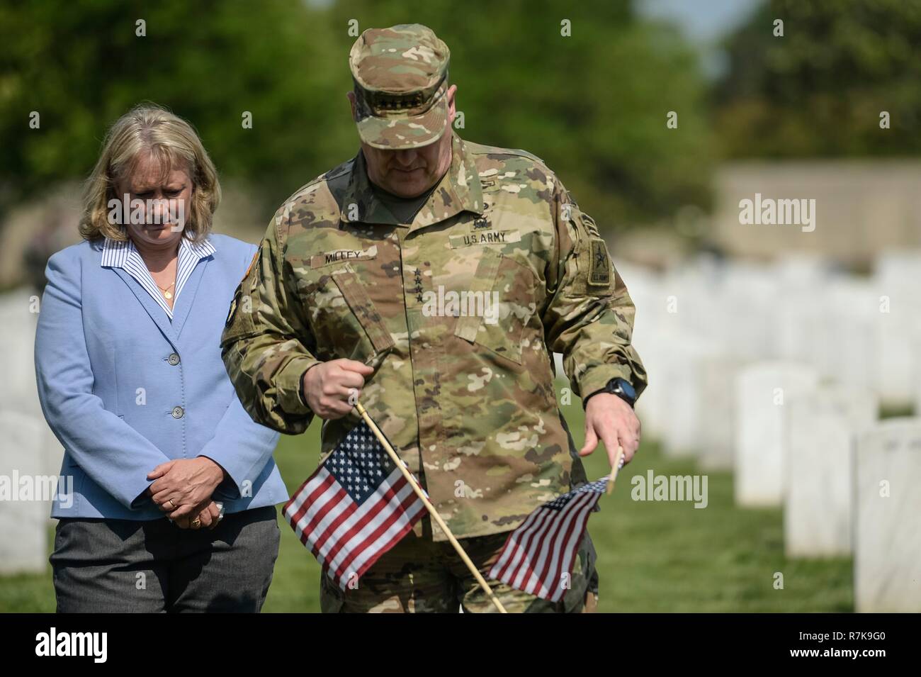 U.S. Army Chief of Staff Gen. Mark Milley and his wife Hollyanne places flags at the graves of fallen soldiers during Memorial Day at Arlington National Cemetery May 26, 2016 in Arlington, Virginia. Milley was chosen by President Donald Trump on December 8, 2018 to be the next Chairman of the Joint Chiefs. Stock Photo