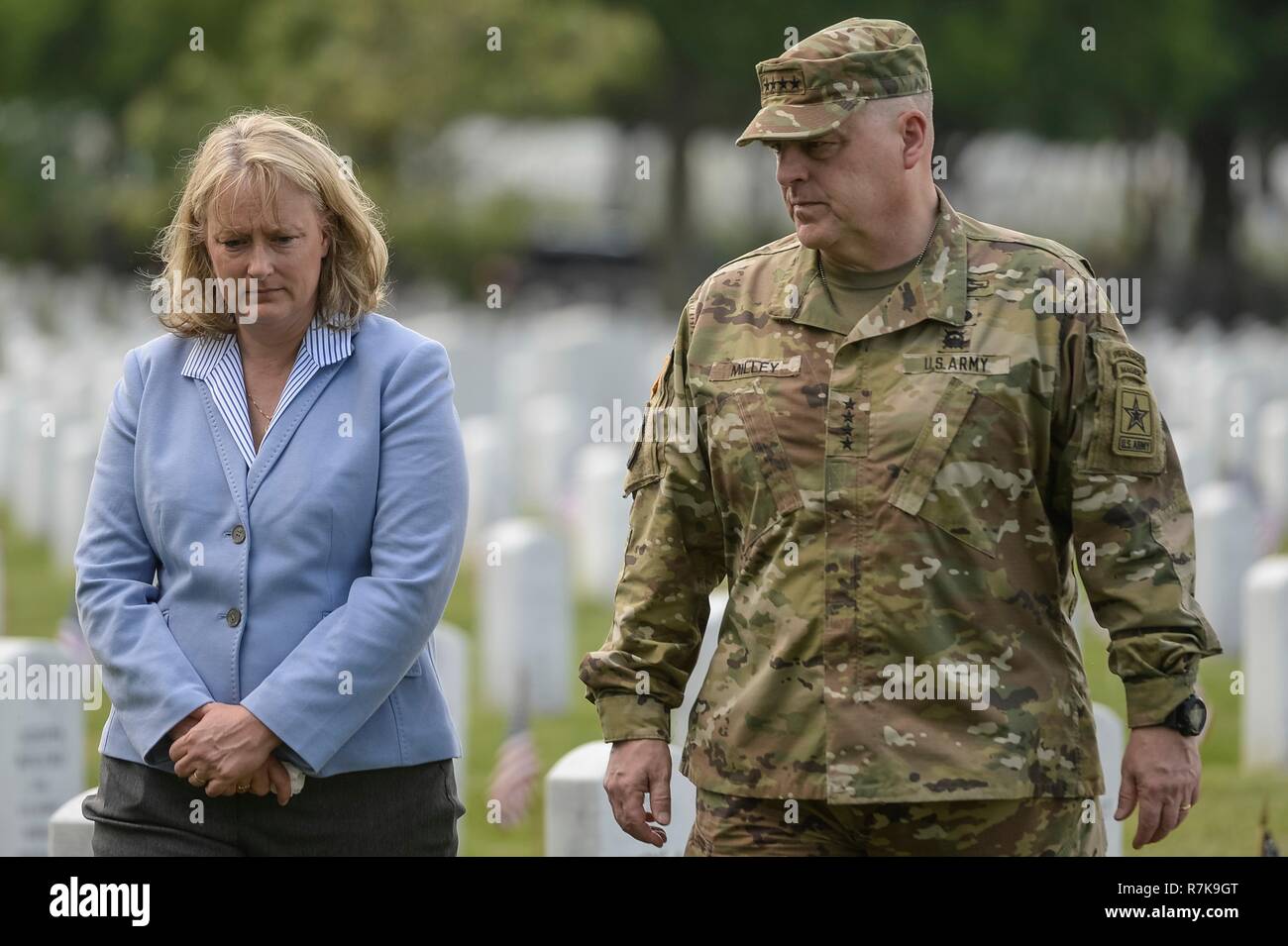 U.S. Army Chief of Staff Gen. Mark Milley and his wife Hollyanne places flags at the graves of fallen soldiers during Memorial Day at Arlington National Cemetery May 26, 2016 in Arlington, Virginia. Milley was chosen by President Donald Trump on December 8, 2018 to be the next Chairman of the Joint Chiefs. Stock Photo