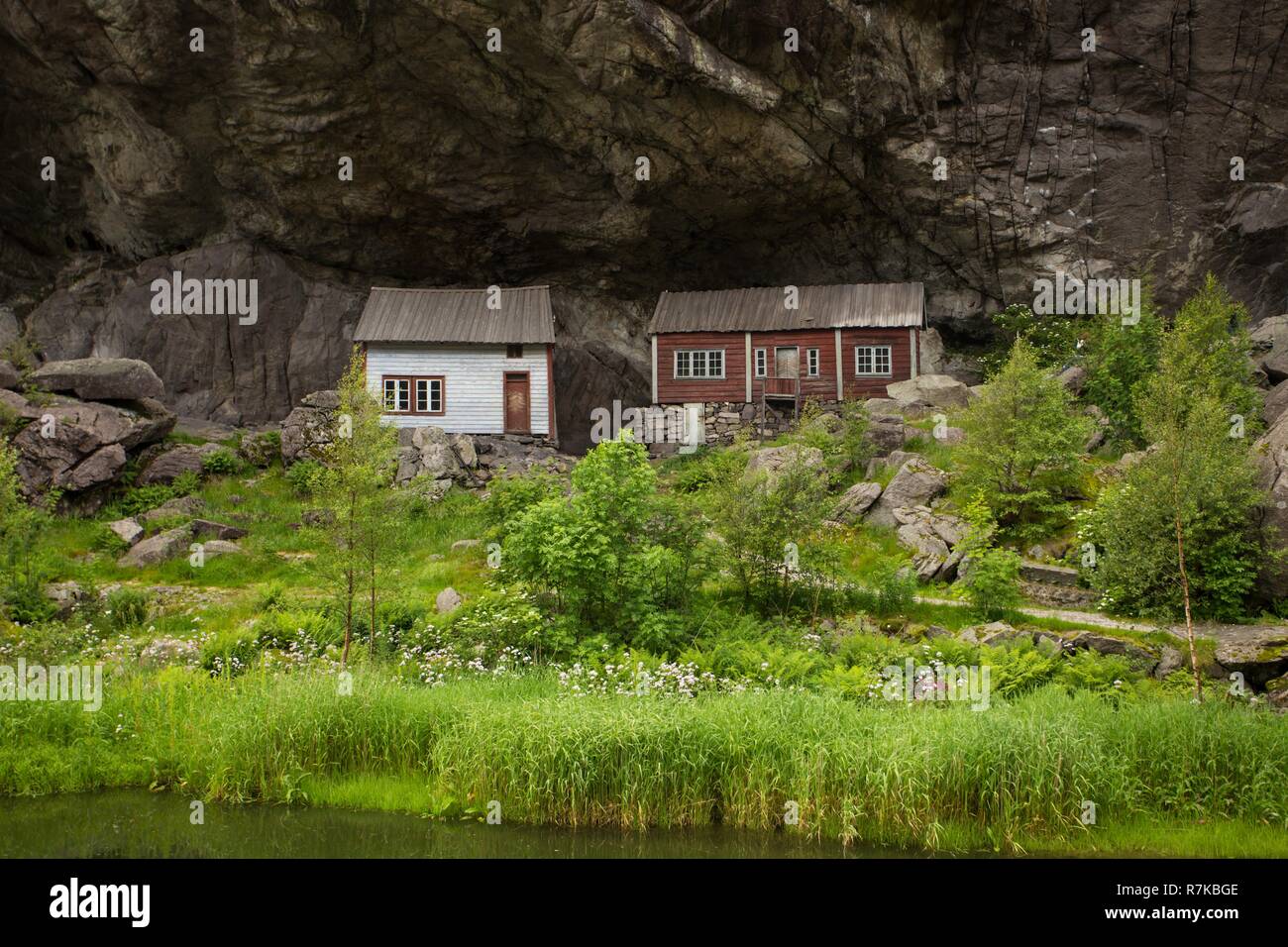 two houses of ancient settlement below rock Helleren,  Jossingfjord, Stavanger, Southern Norway Stock Photo