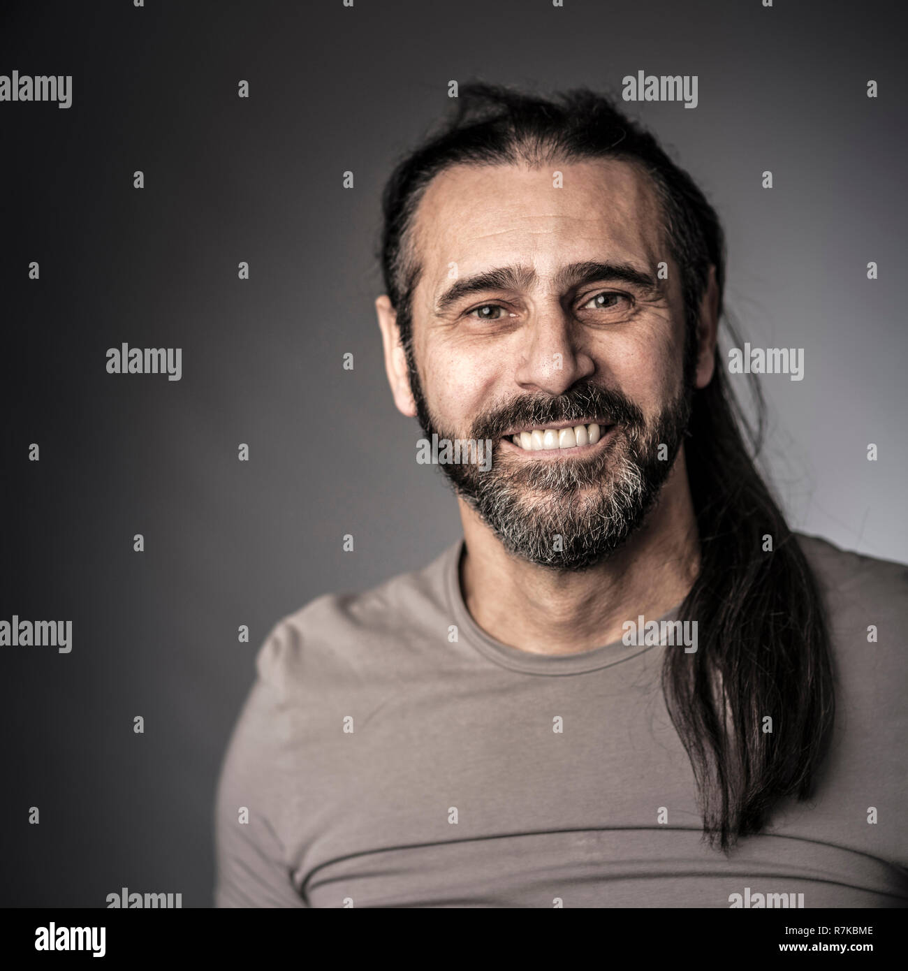 happy man with long hair studio shot Stock Photo