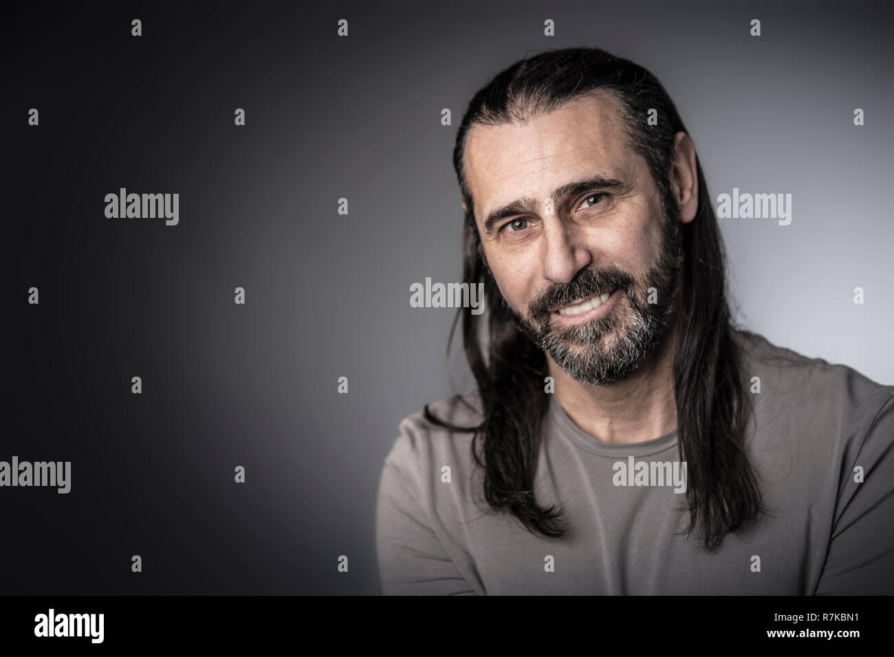 portrait of man with long hair studio shot Stock Photo
