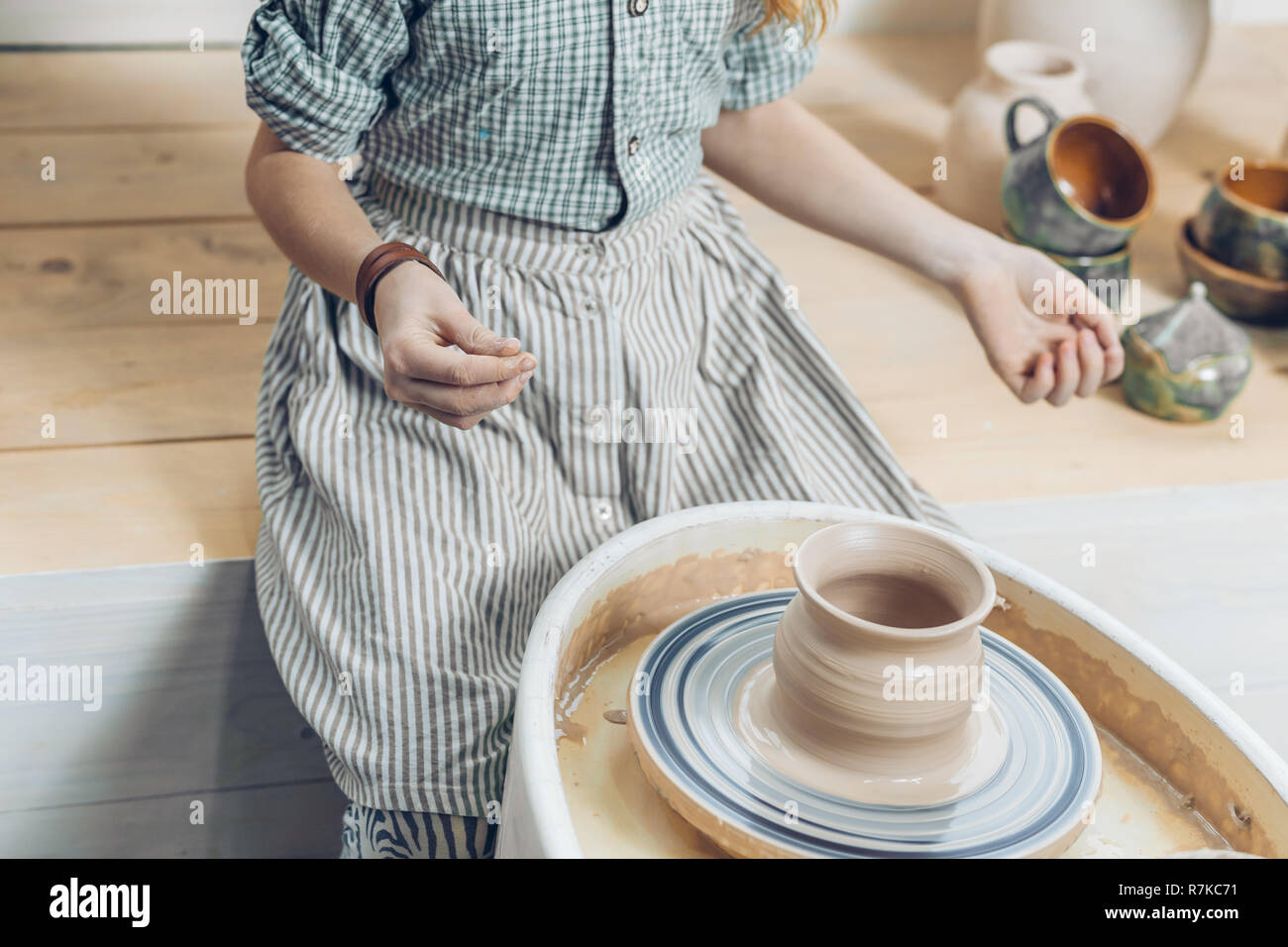 ready handmade pottery. woman has finished to make a pot Stock Photo
