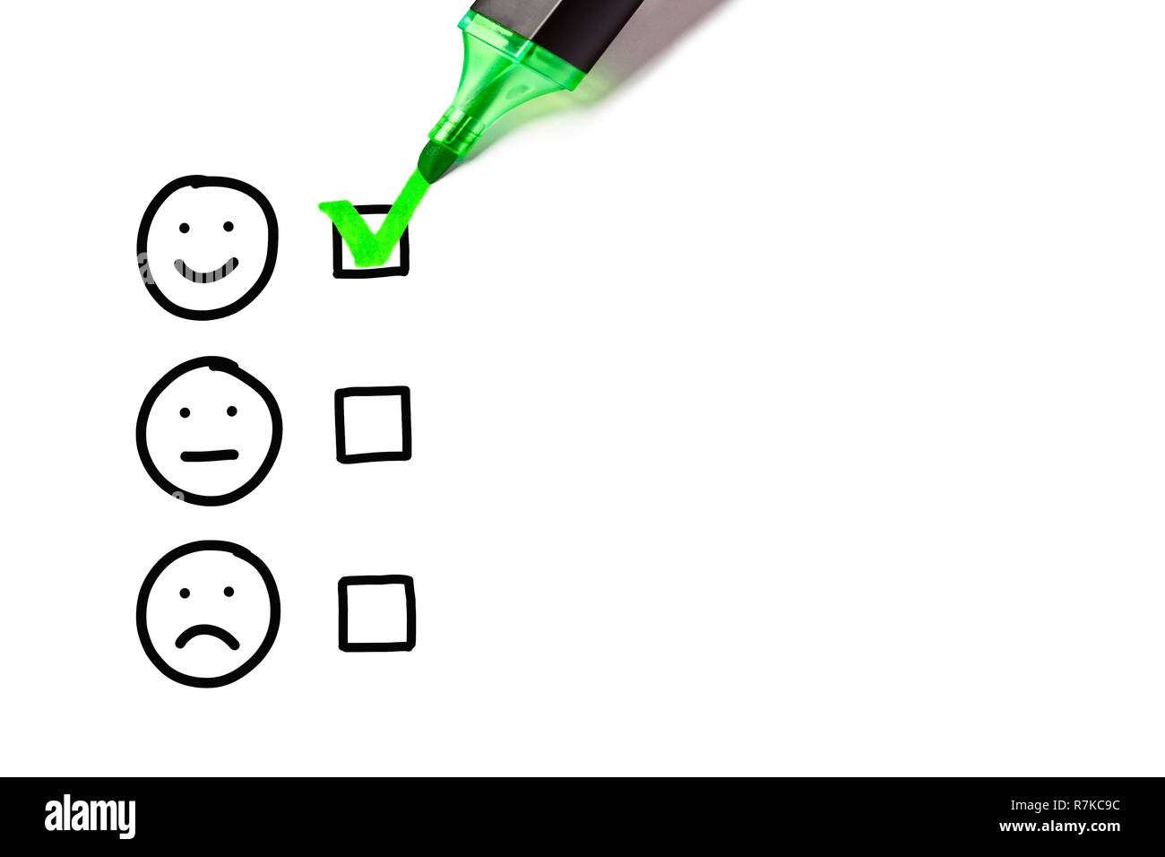 Green marker putting check mark on blank excellent survey checklist next to drawn happy face. Customer satisfaction concept. Stock Photo