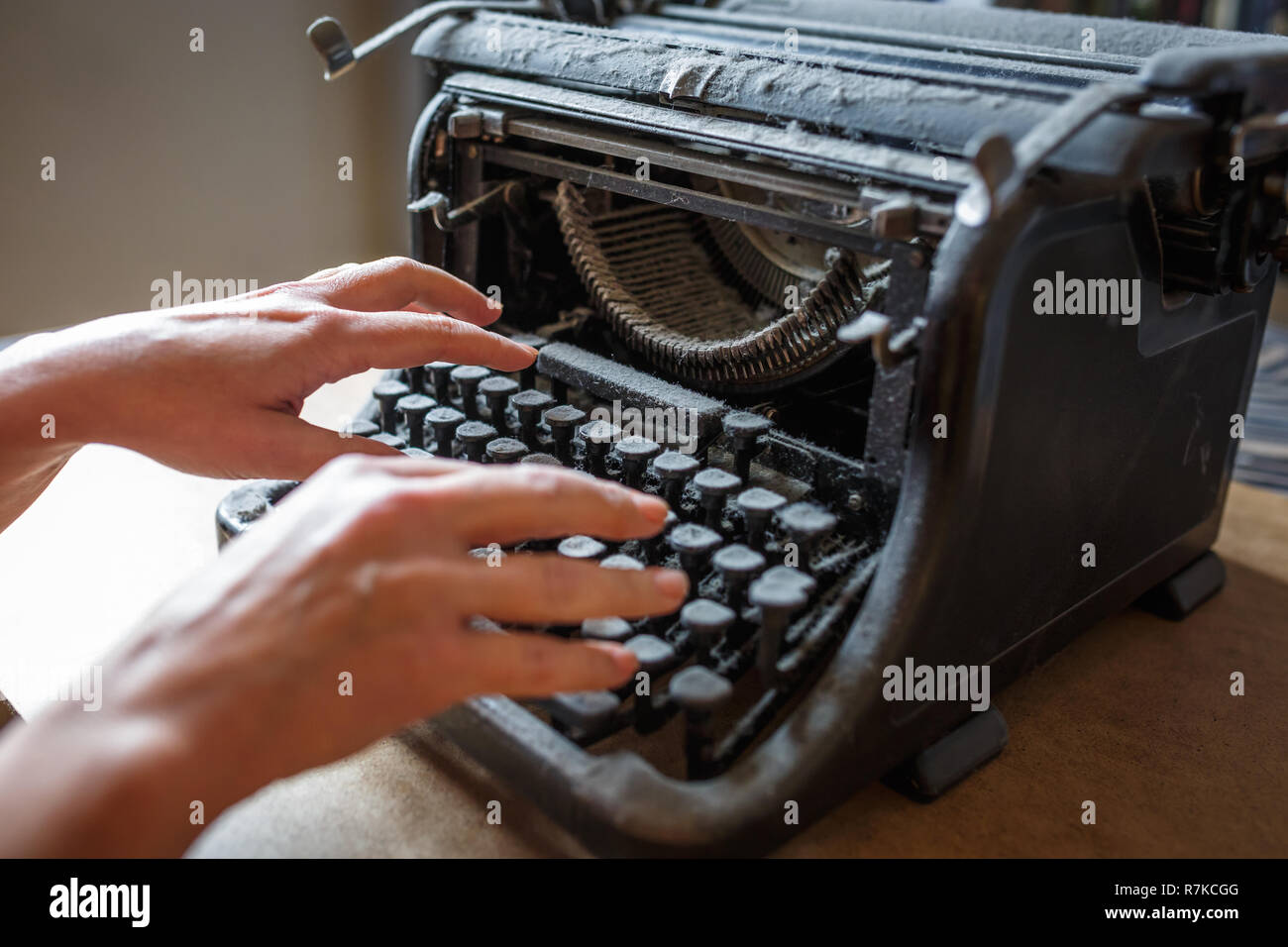 woman hands type on an old vintage dust-covered typewriter Stock Photo