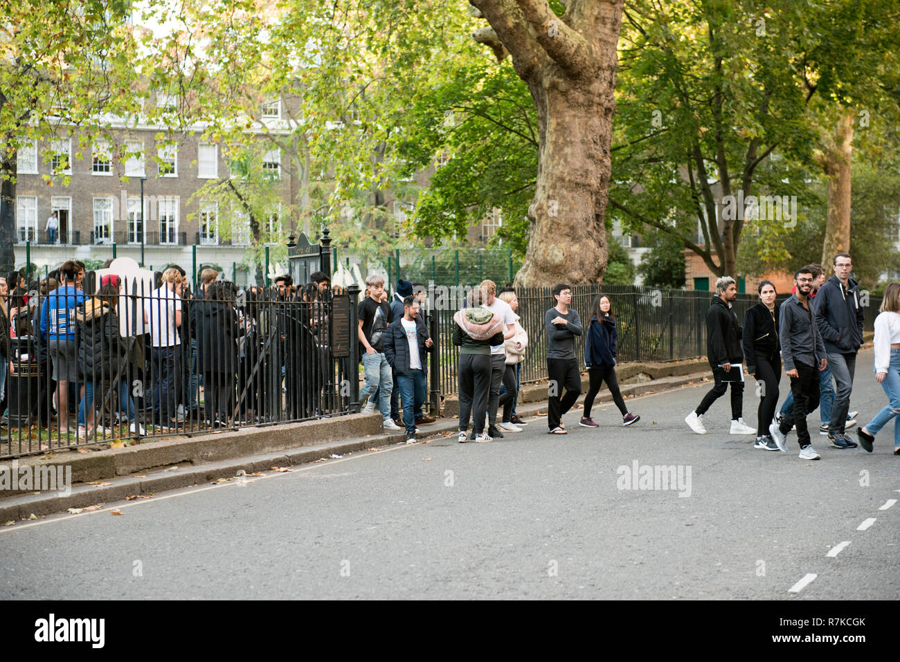 People crossing road during fire drill evacuation Cartwright Gardens, Bloomsbury, London England Britain UK Stock Photo