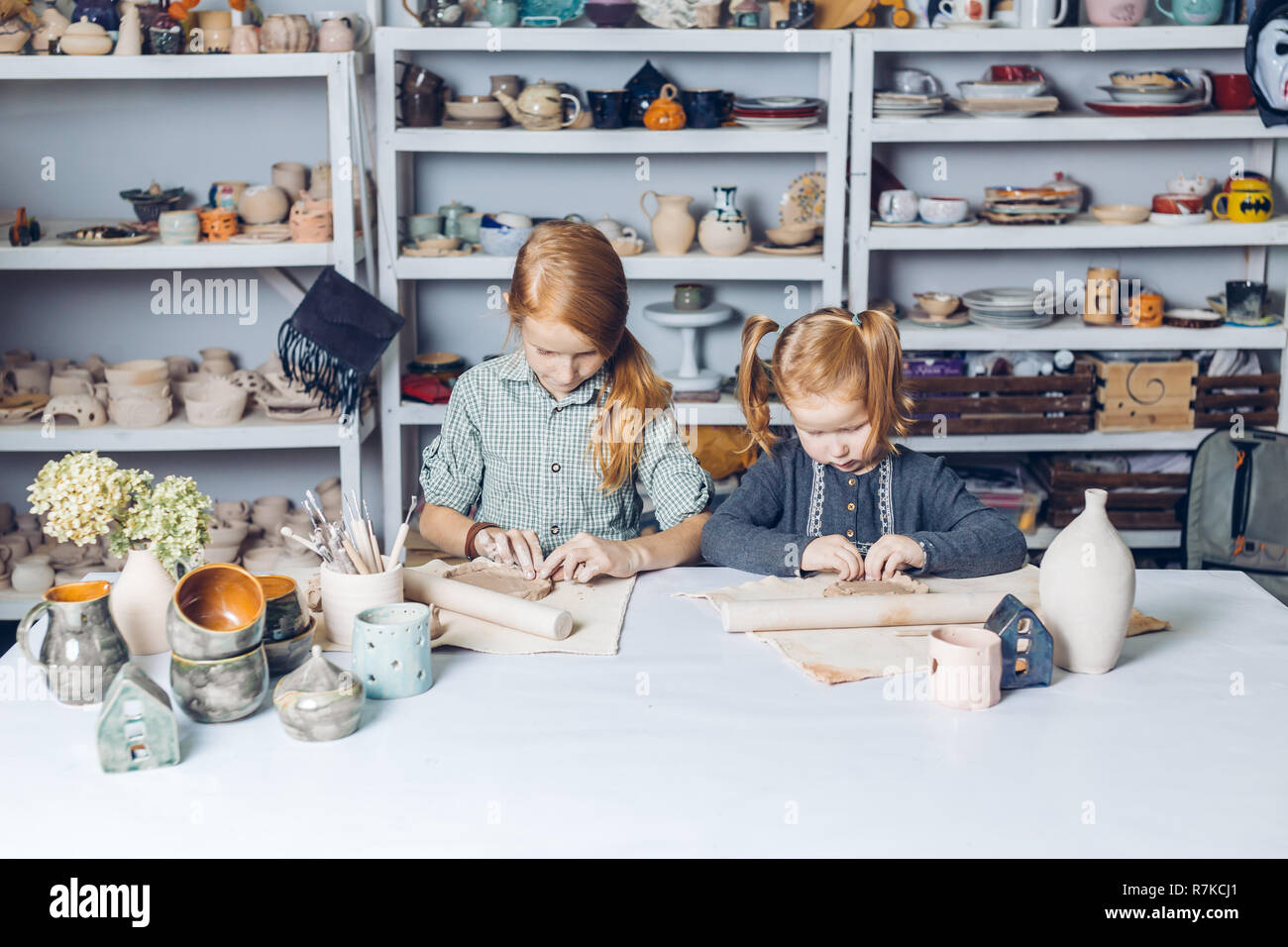 two clever kids modeling in clay Stock Photo