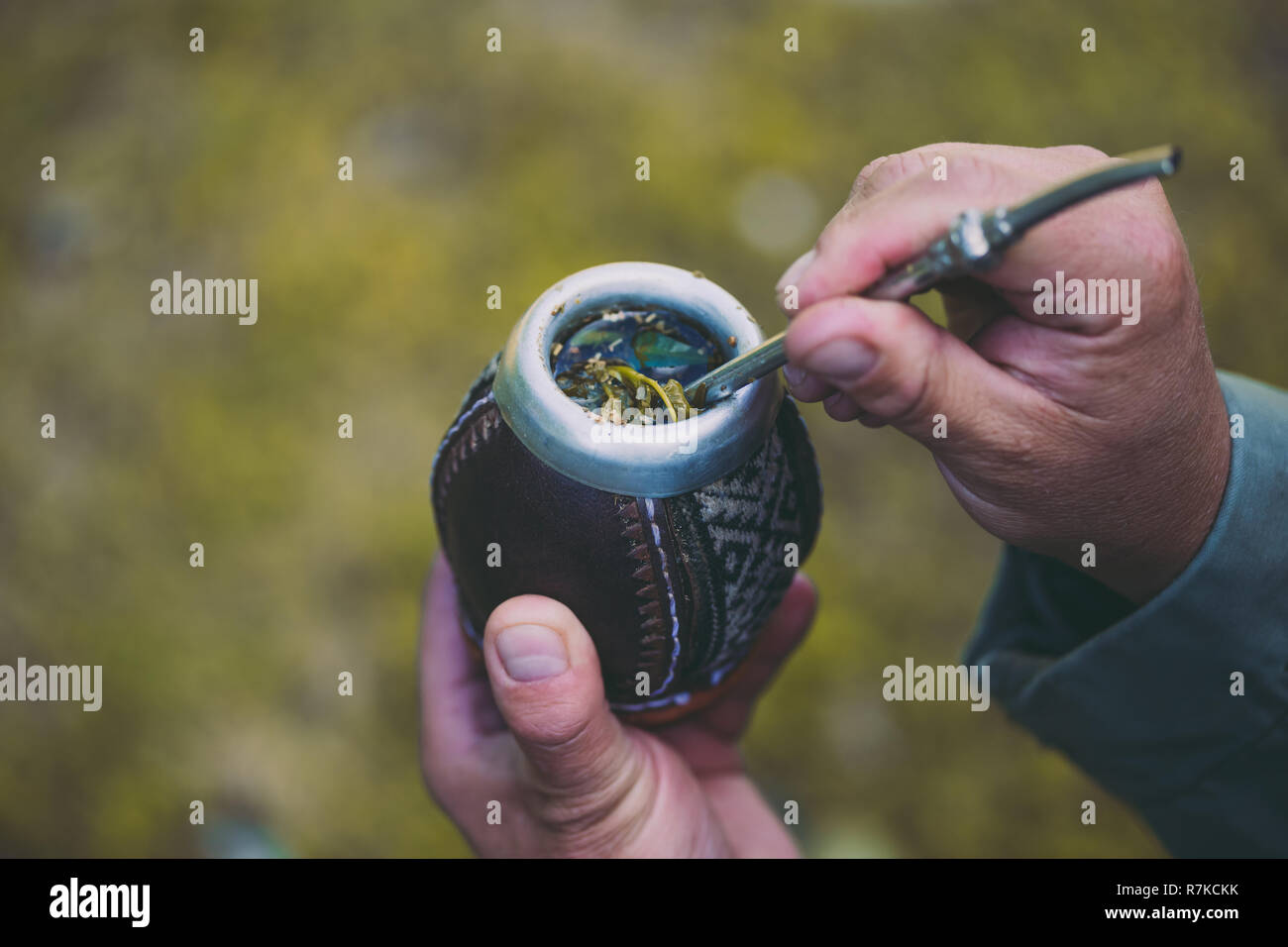 Man holding yerba mate in nature. Travel and adventure concept. Latin American drink yerba mate
