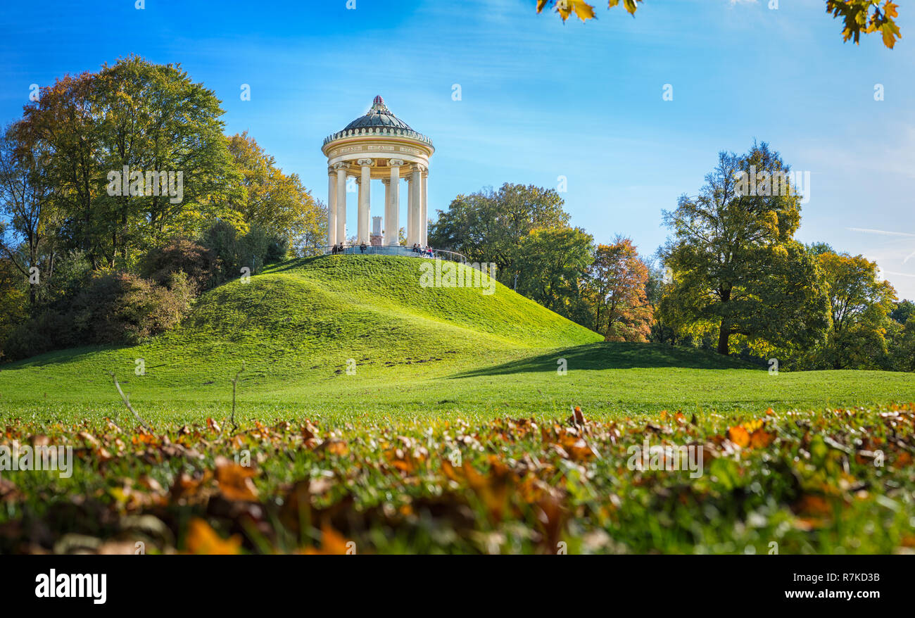 MUNICH, GERMANY - OCTOBER 11, 2017: Monopteros building in the English Garden in Munich in autumn. People sitting at the base of the building. Stock Photo