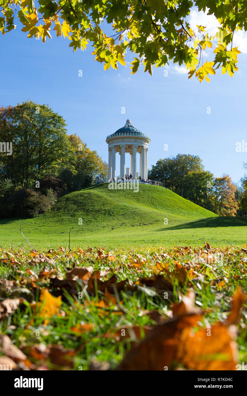 MUNICH, GERMANY - OCTOBER 11, 2017: Monopteros building in the English Garden in Munich in autumn. People sitting at the base of the building. Stock Photo