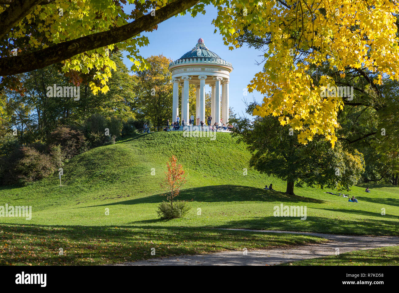 MUNICH, GERMANY - OCTOBER 11, 2017: Monopteros building in the English Garden in Munich in autumn. People sitting at the base of the building. Stock Photo