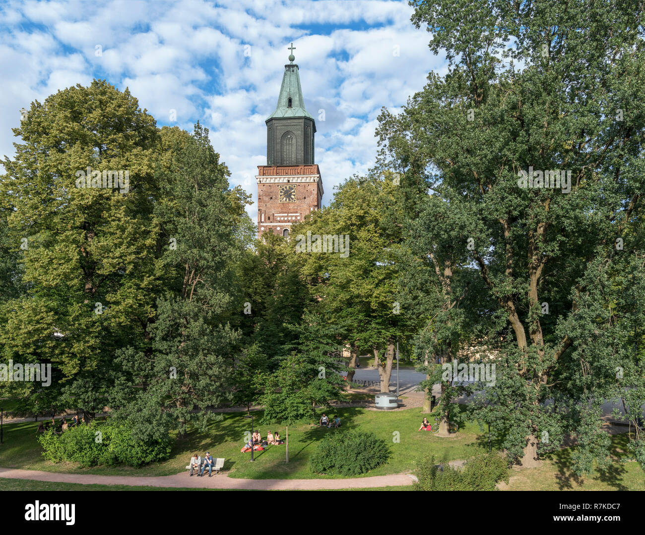 Young people sitting in Tuomiokirkonpuisto (Cathedral Park) in evening