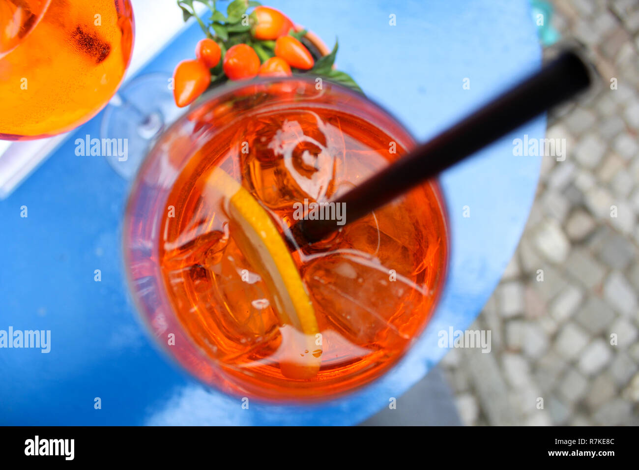 Orange summer drink with ice cubes and lemons Stock Photo
