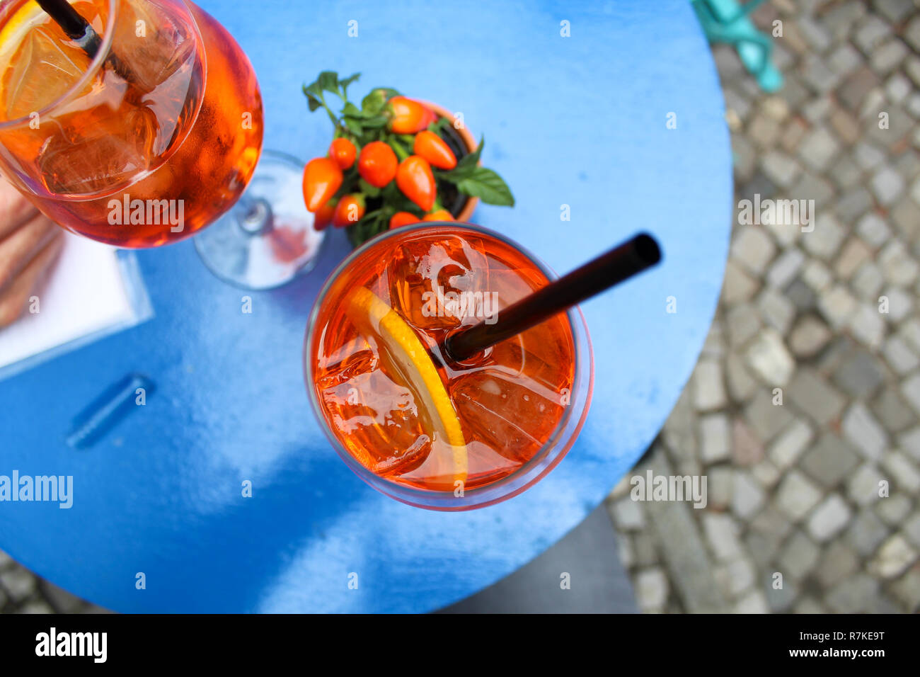 Orange summer drink with ice cubes and lemons Stock Photo