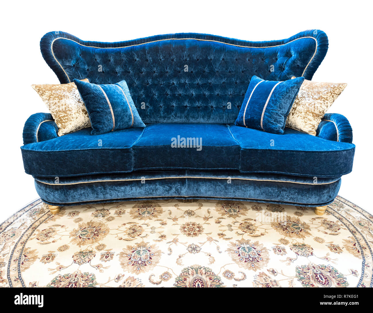 Blue velours sofa with pillows. Soft luxury classical couch with cushions isolated background Stock Photo