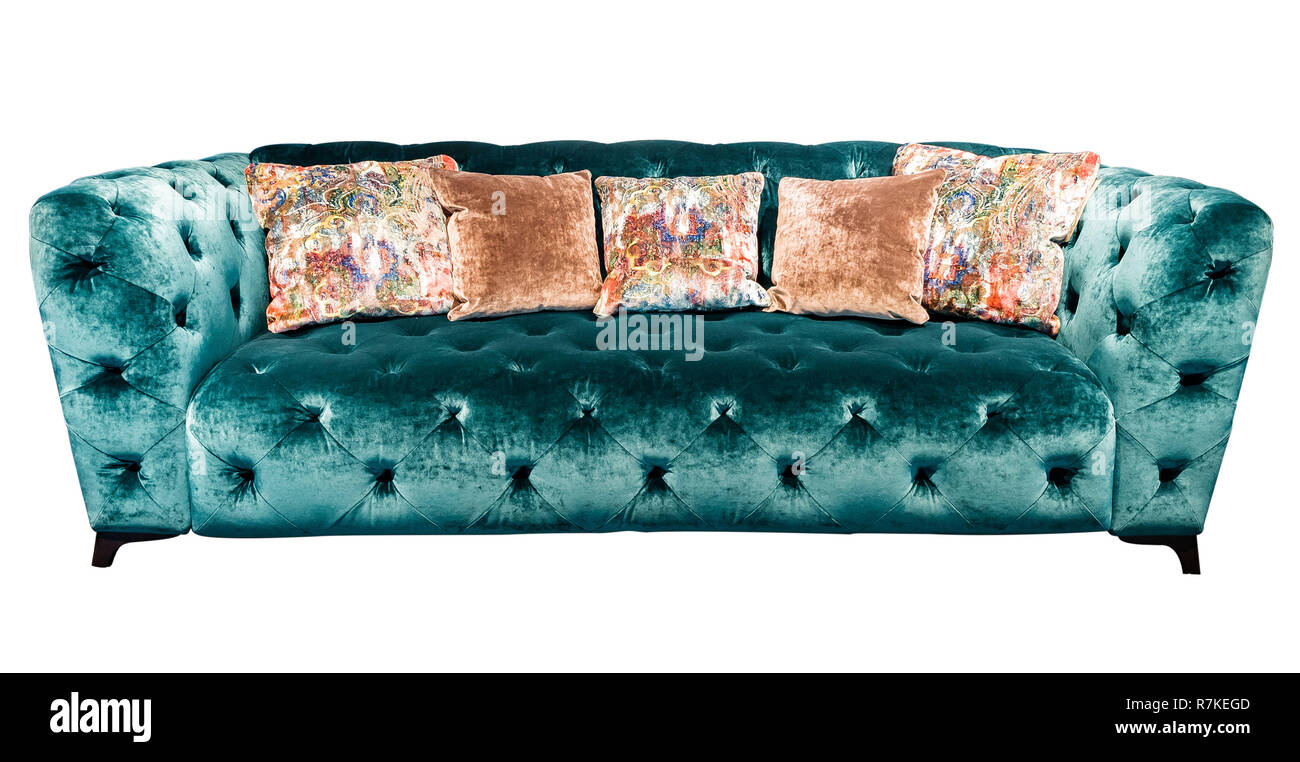 Green velours sofa with pillow. Soft emerald couch with cushions isolated background. Stock Photo