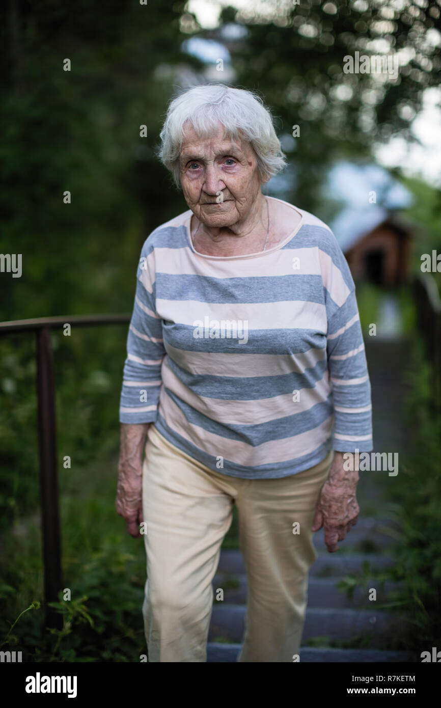An elderly woman walking outdoor Stock Photo - Alamy