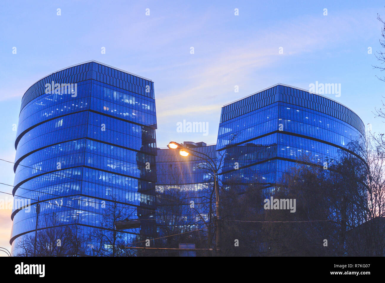 The glass building is not tall with transparent windows in blue Stock Photo