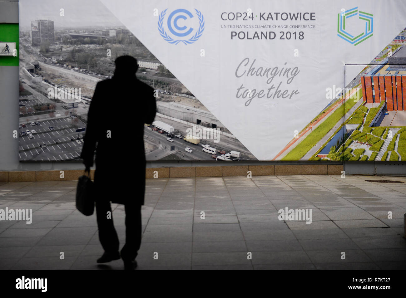 A participant seen passing by COP24 advert next to the venue of UN Climate change conference (COP24). The 2018 United Nations climate change conference (COP24) is now entering the second week of negotiations and ends on 14th December in Katowice. Stock Photo