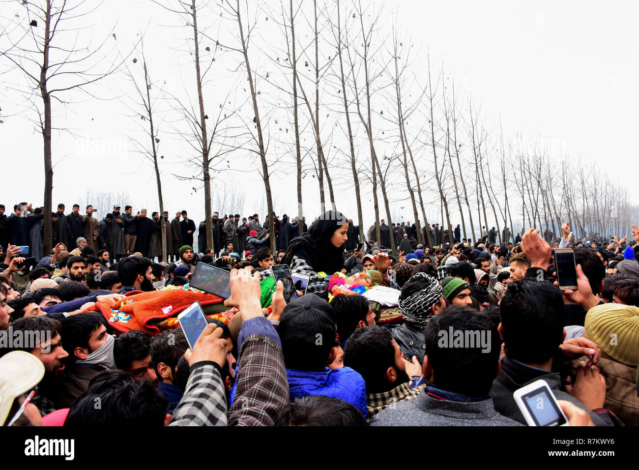 December 10, 2018 - Thousands of mourners carry the body of alleged rebels Mudasir Parray, 14, and Mudasir Parray, 17, during their funeral procession in the Hajin Village of the Bandipura district in Indian Administered Kashmir on 10 December 2018. Mudasir Parray and Saqib Sheikh were killed together with a third militant in a 18-hour-long gun battle with Indian Forces in the Mujgund area of Srinagar on 09 December. According to the police, Parray is the youngest fighter killed in the decades-long insurgency in Indian administered Kashmir (Credit Image: © Muzamil Mattoo/IMAGESLIVE via ZUMA W Stock Photo