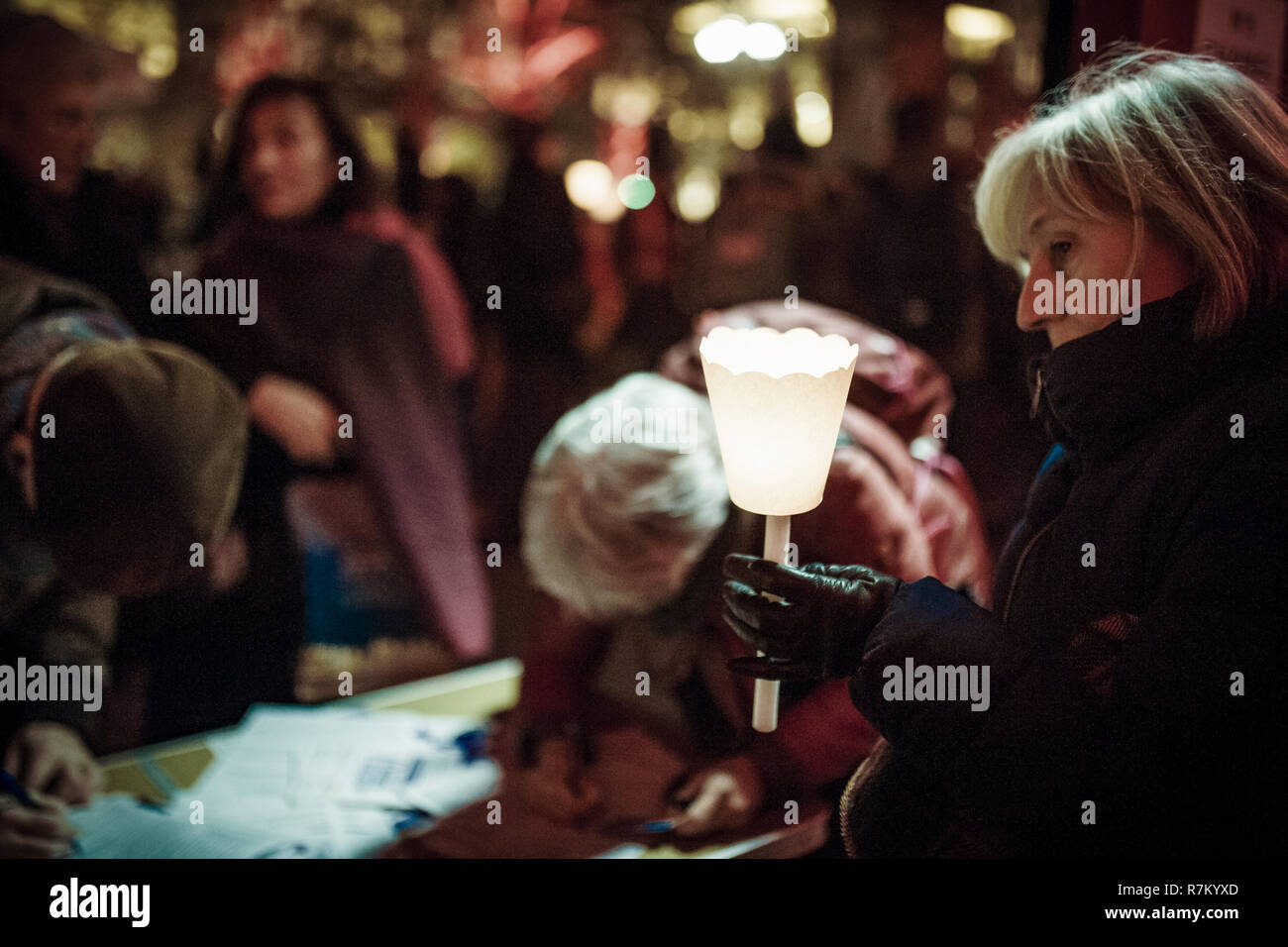 Milan, MI, Italy. 10th Dec, 2018. An Italian lady seen holding a candle during the event.Amnesty International Italia, Caritas, Emergency Oxfam and Action Aid organized in Milan, and almost other 80 Italian cities a torchlight in order to celebrate the 70 years of the Universal Declaration of Human Rights. With the rising xenophobic acts in the country, the organizing associations would like to underline the importance of the contents and values of the Declaration. Credit: Valeria Ferraro/SOPA Images/ZUMA Wire/Alamy Live News Stock Photo