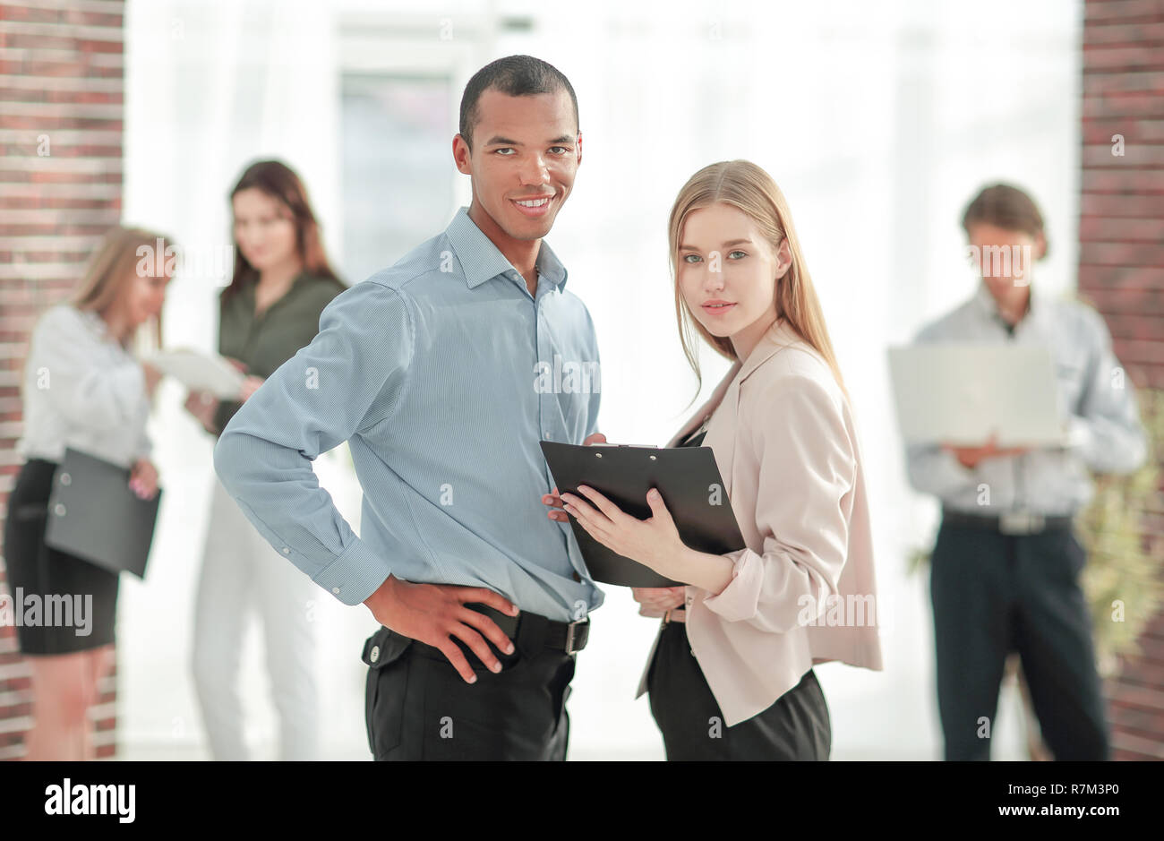 business couple standing in a modern office Stock Photo - Alamy