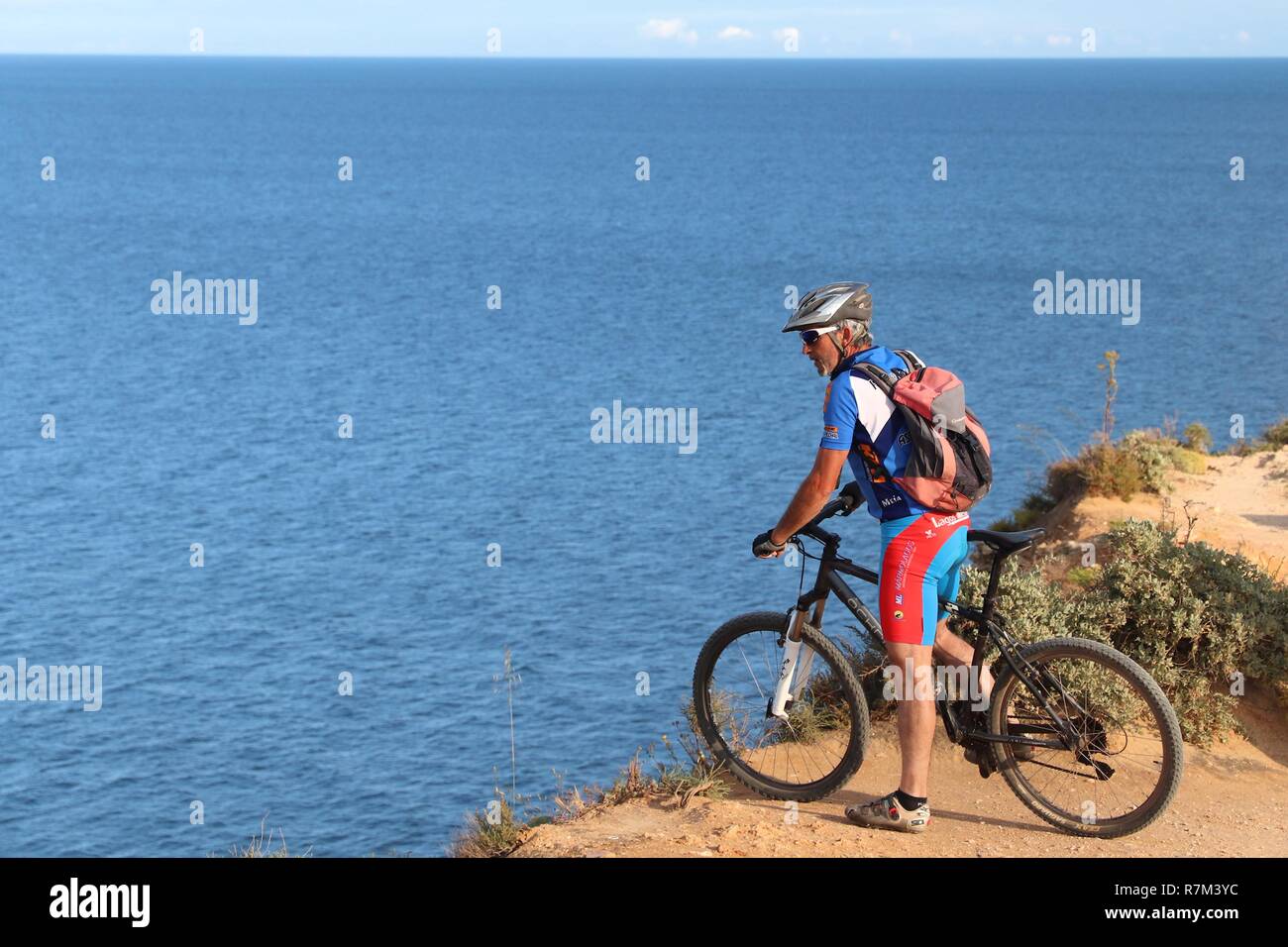 ALGARVE, PORTUGAL - MAY 29, 2018: Tourist enjoys mountain biking adventure in Algarve region, Portugal. Coastal region of Algarve attracts more than 1 Stock Photo