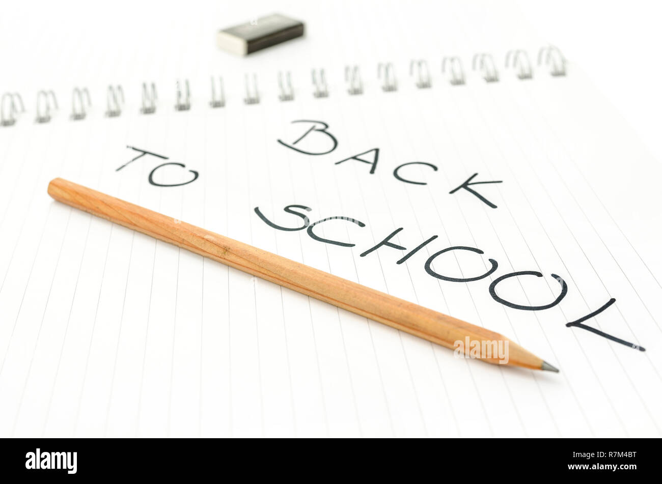 Back to school text written in spiral notebook underlined with pencil ...