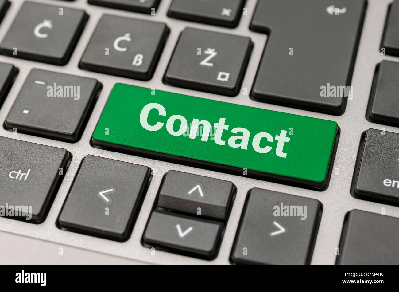 Green Contact button on computer keyboard. Stock Photo