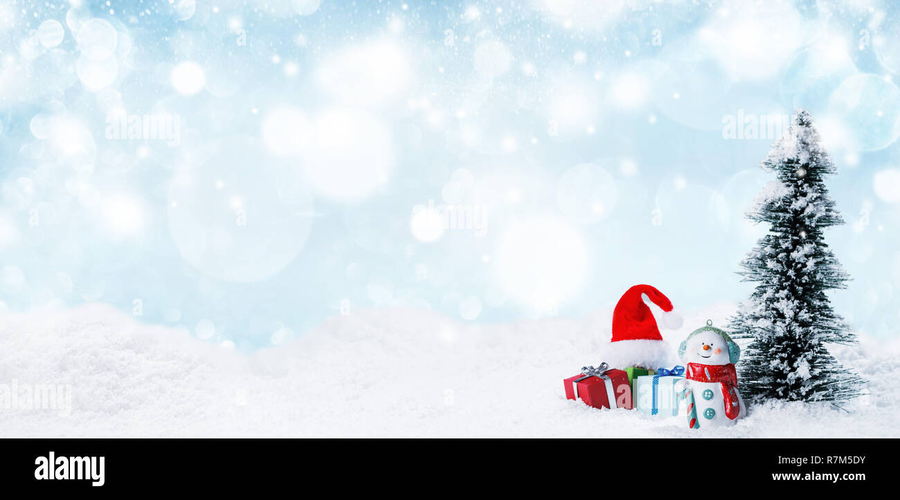 Snowman fir tree and christmas gifts on sleigh on snow, blue and white ...