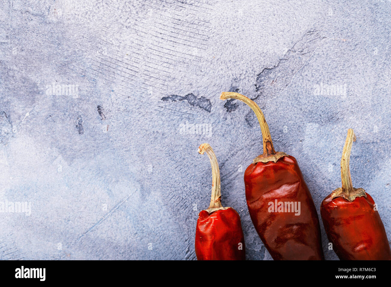 Dry red peppers on table with copy space, top view Stock Photo - Alamy