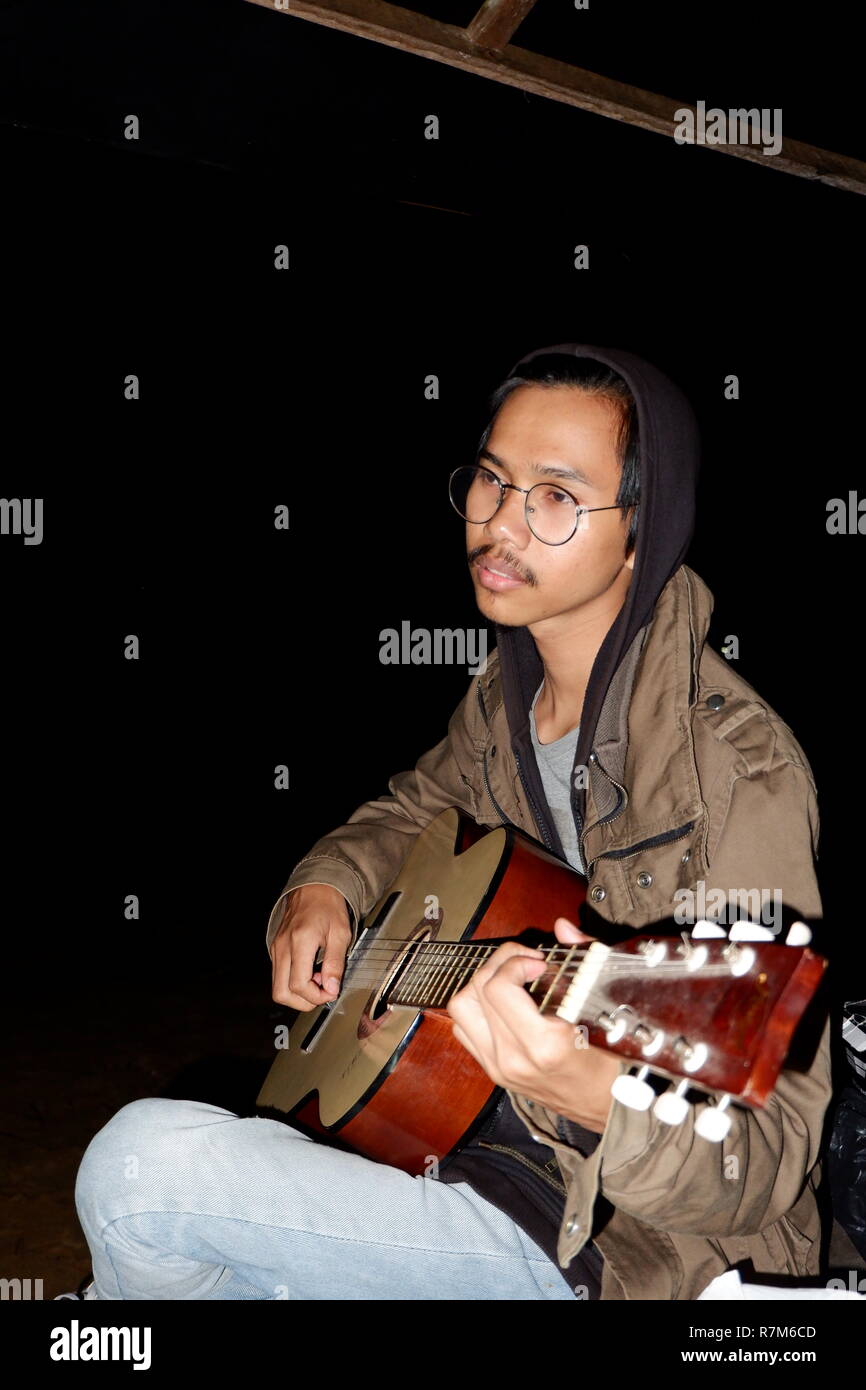 man playing guitar at night Stock Photo