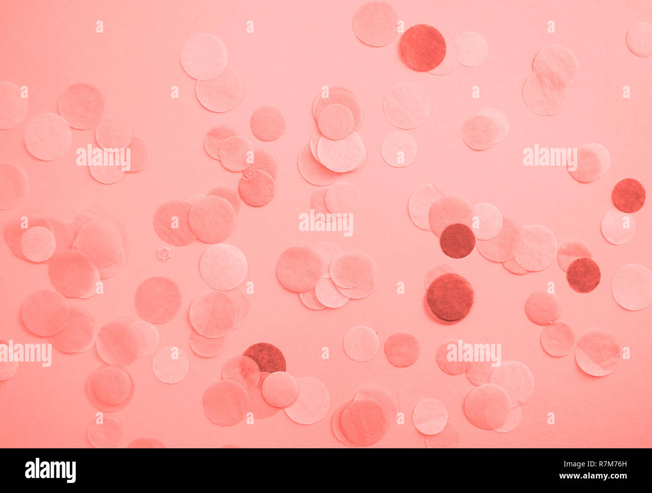 Flat lay of living coral color confetti and sparkles on pink background. Color of the year 2019 concept. Stock Photo