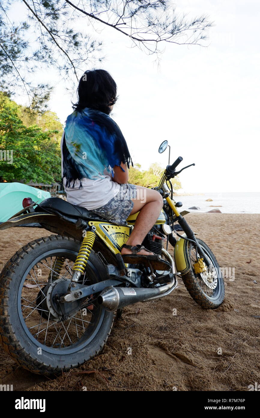 man posing with his motorcycle in the beach Stock Photo