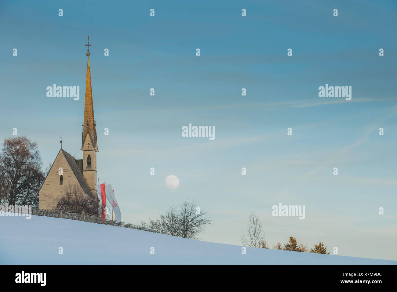 Church on a winter day with blue sky and visible moon Stock Photo - Alamy