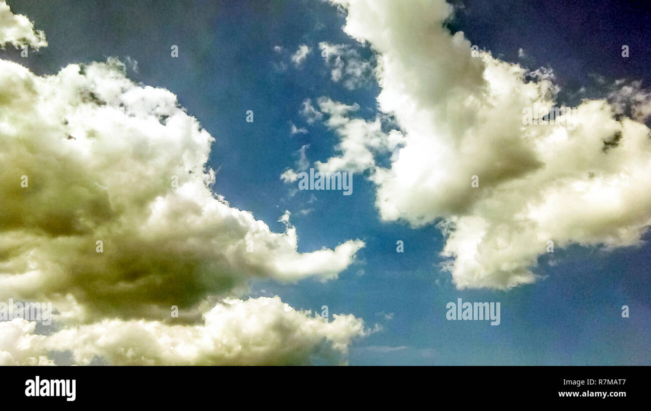 cumulus clouds like fluffy, white cotton balls on the blue sky