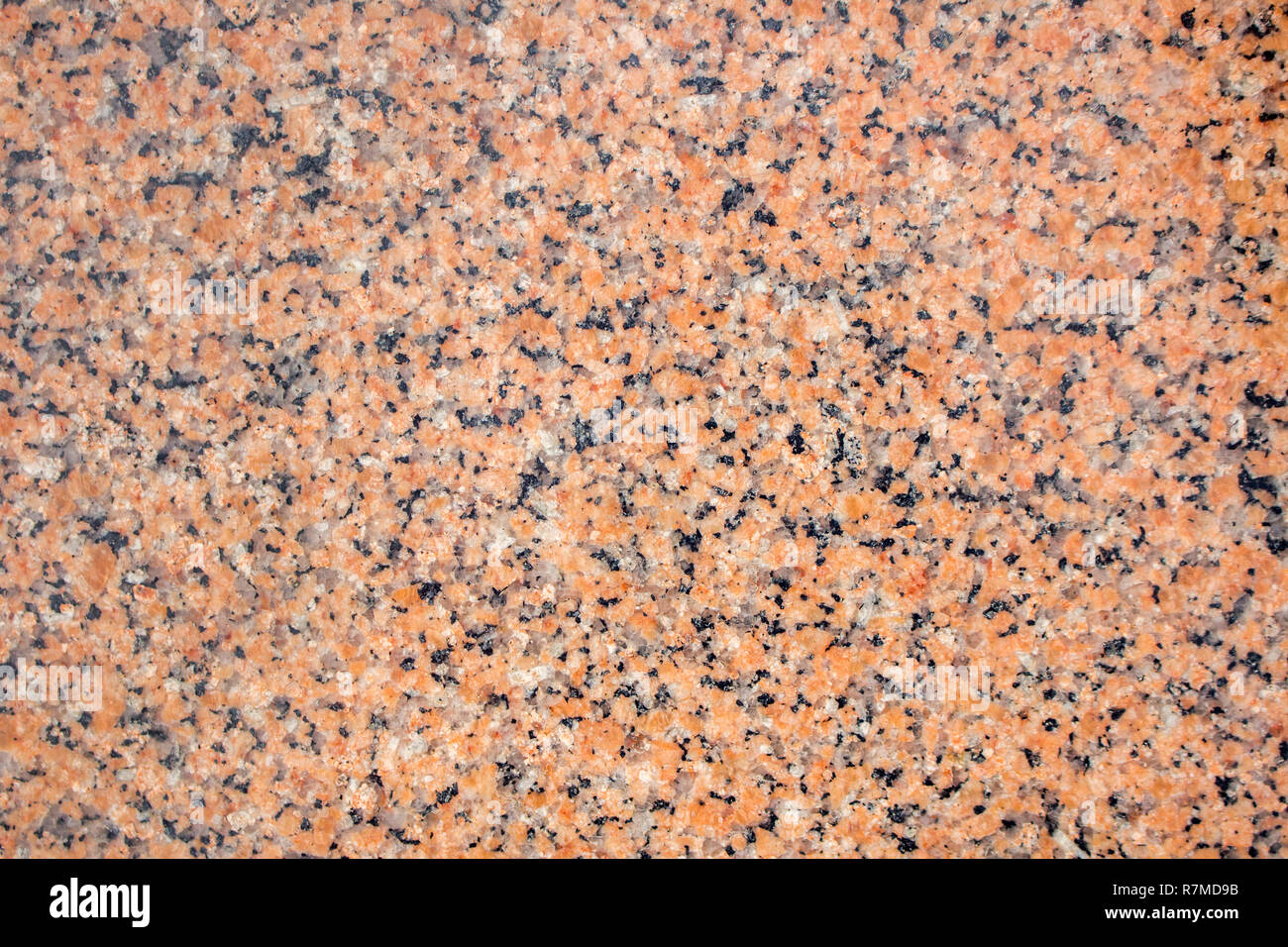 Orange granite stone background. Black, gray and orange colored granite