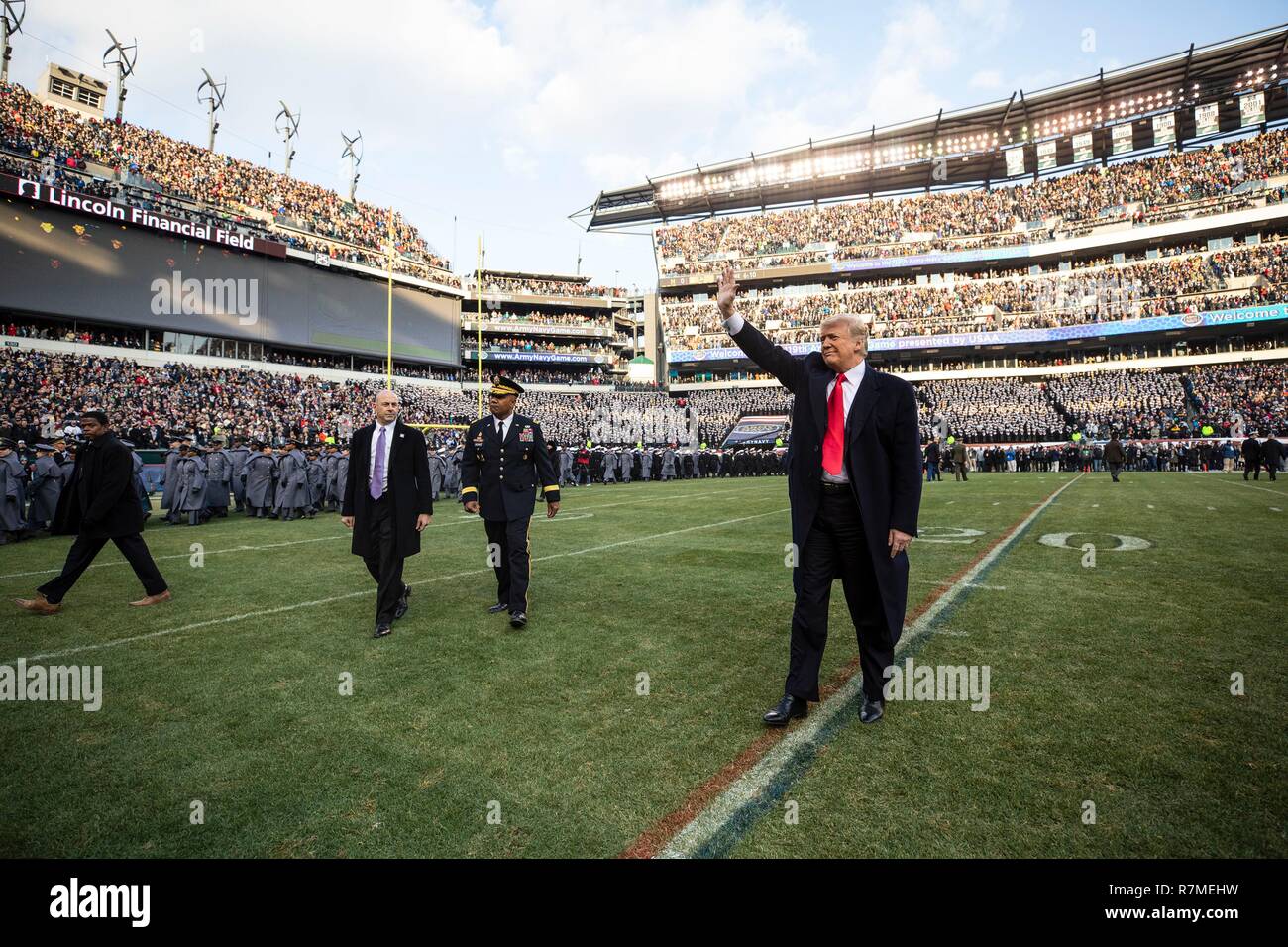 U.S President Donald Trump waves as he walks onto the playing field before the start of the 119th Army Navy game at Lincoln Financial Field December 8, 2018 in Philadelphia, Pennsylvania. Stock Photo