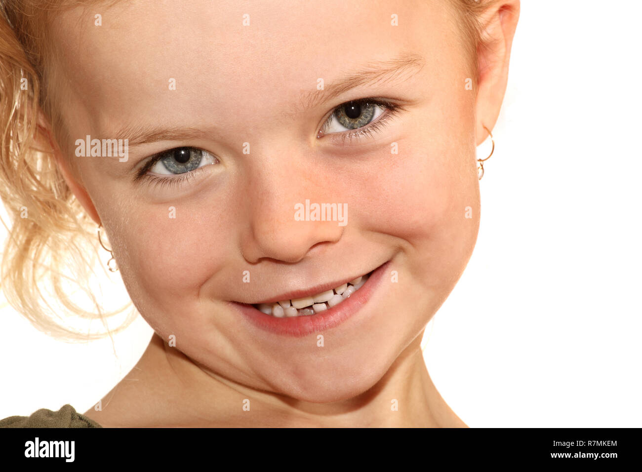 A close up image of a six year old girl smiling at the camera Stock